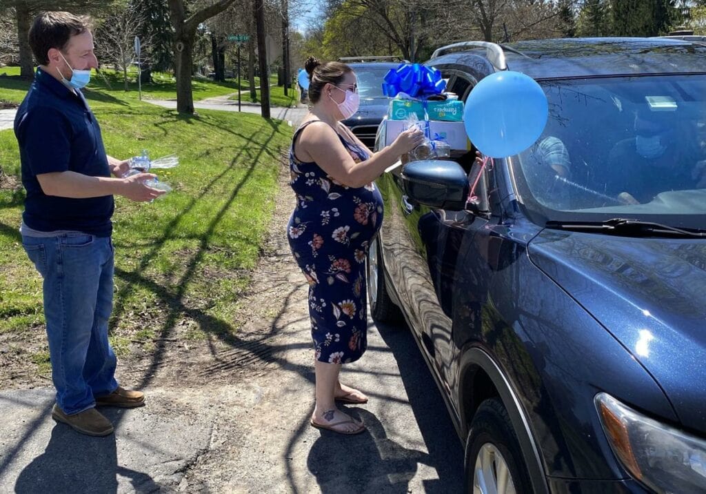 webbabyshower mom receiving gifts during drive by baby shower