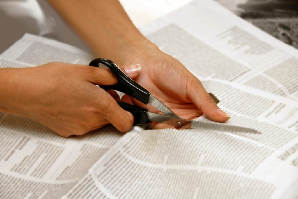 cutting newspaper