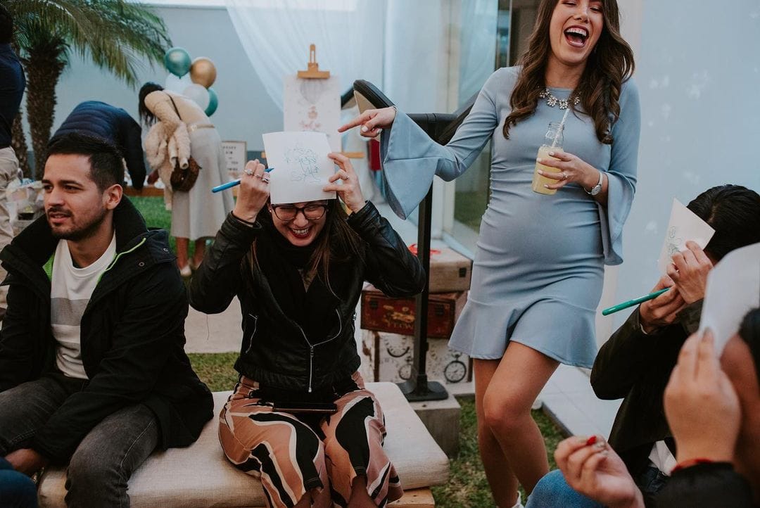 mom-to-be laughing during draw the baby game