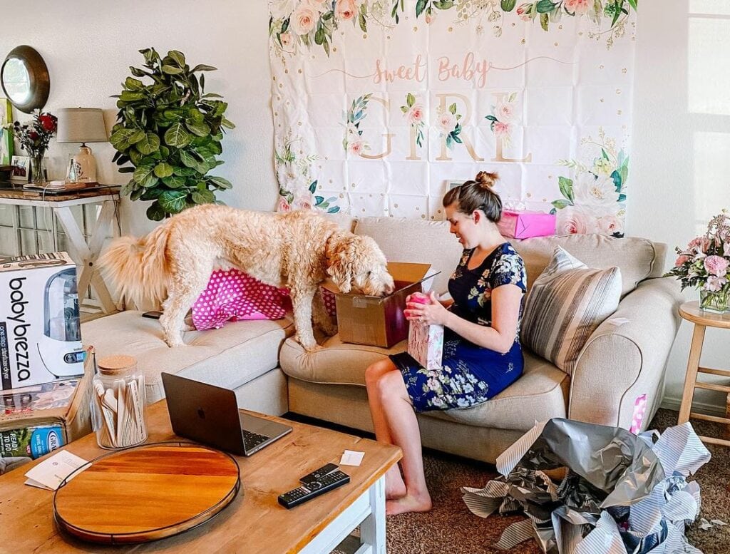 mom opening a gift during virtual baby shower